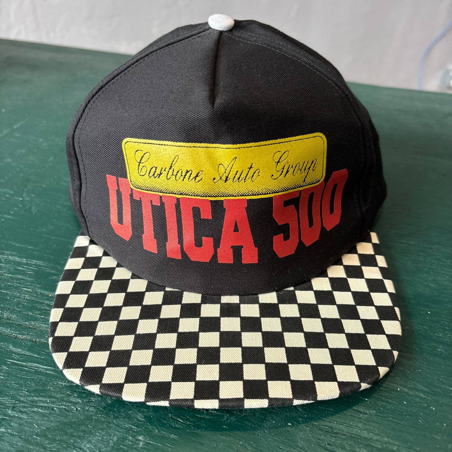 Vintage Utica 500 Hat Snapback with Checkered Bill. Carbon Auto Group.